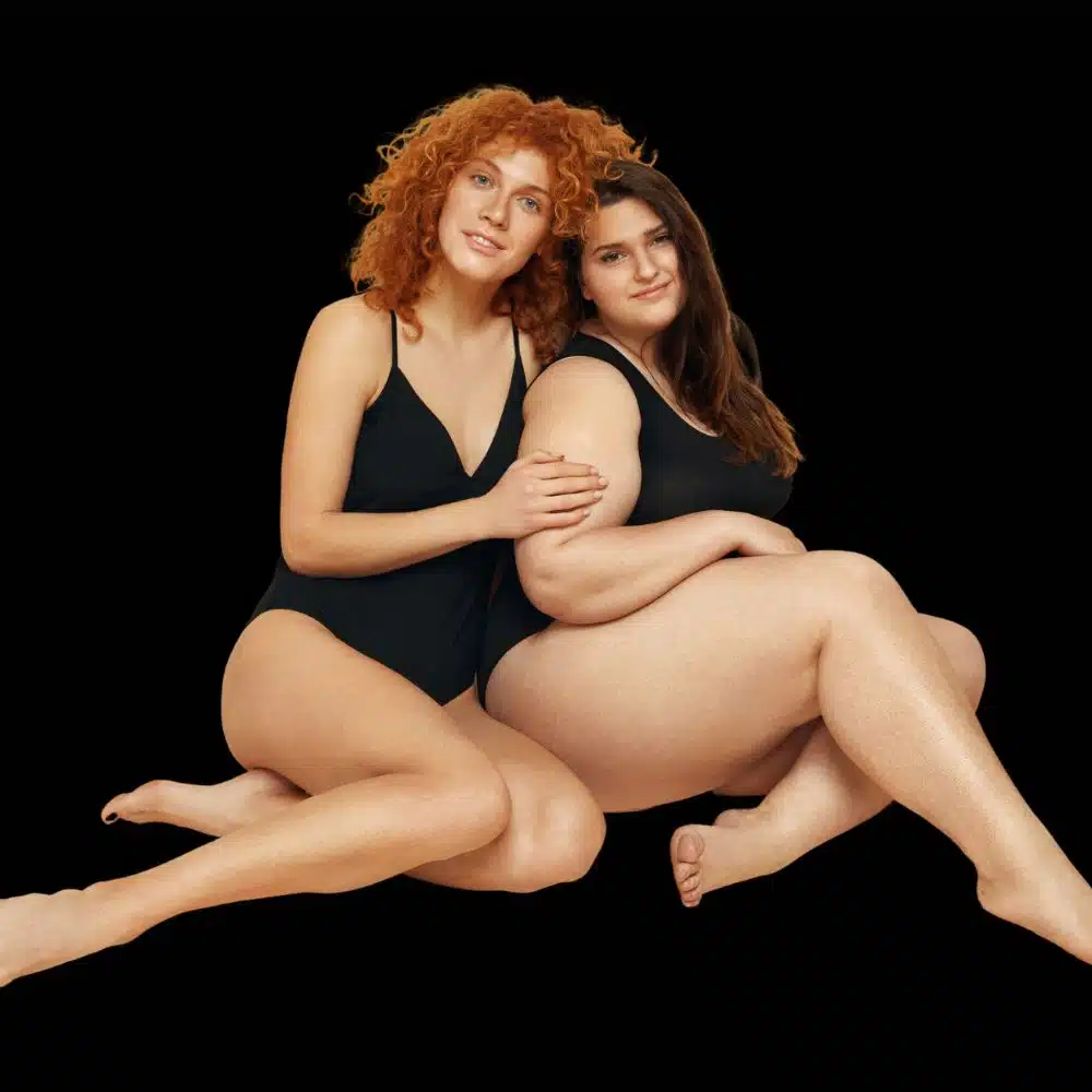 Two smiling women in black swimwear promote Tirzepatide injections for weight loss at Revenge MD in Henderson and Reno, Nevada.