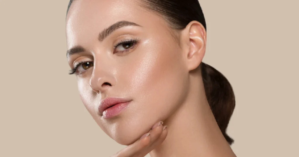 Young woman with smooth, lifted skin touching her jawline, showing results from PDO Threads in Las Vegas, NV
